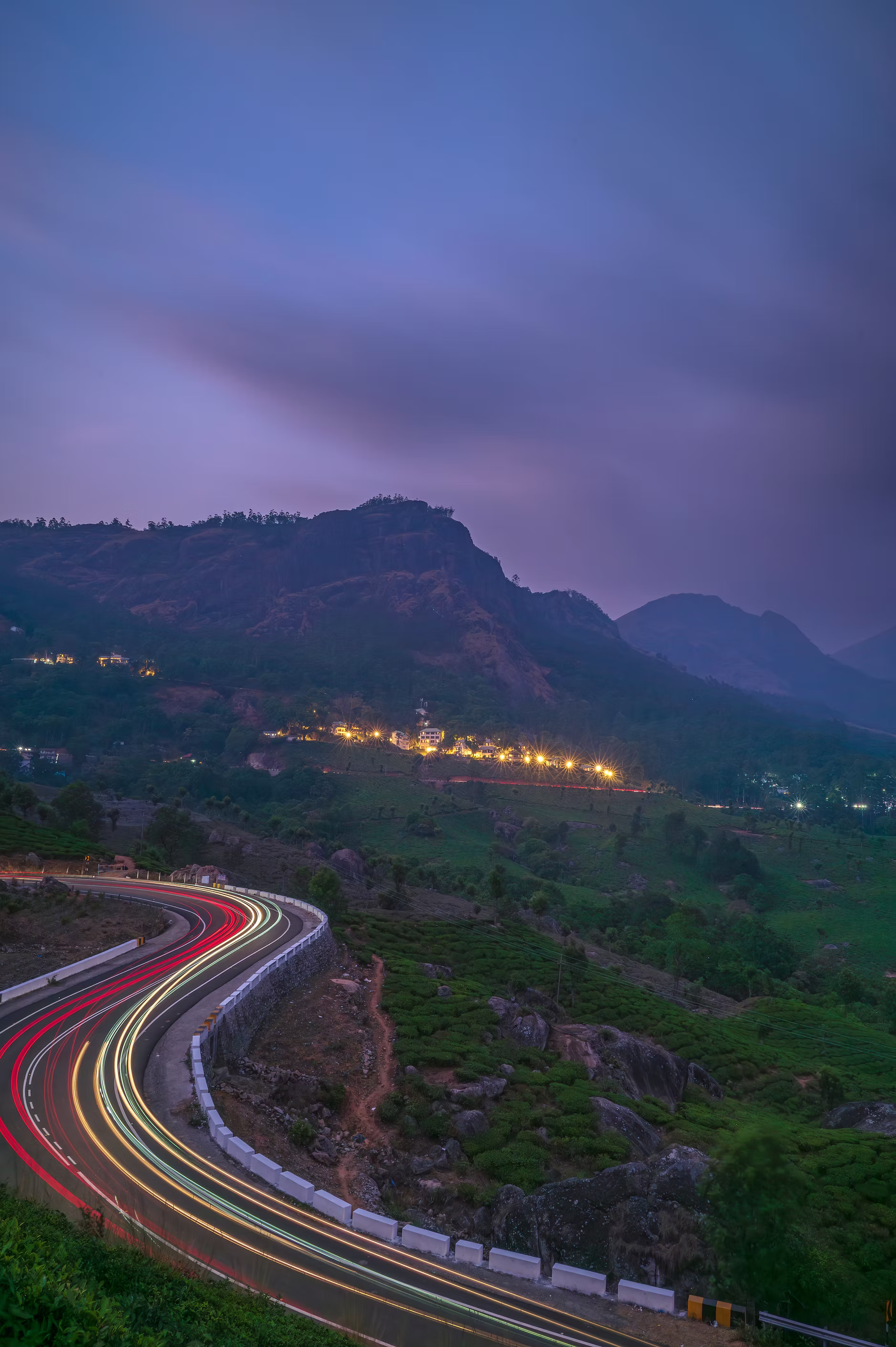 Highway light trails through Munnar hills